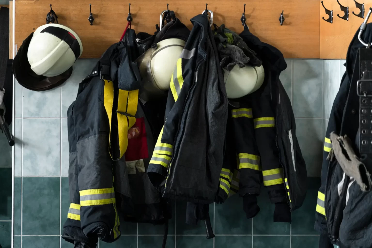firefighter-suits-hanging-from-wall-station